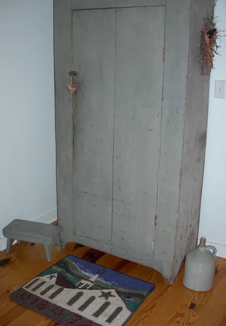 A grey cupboard in the bedroom.