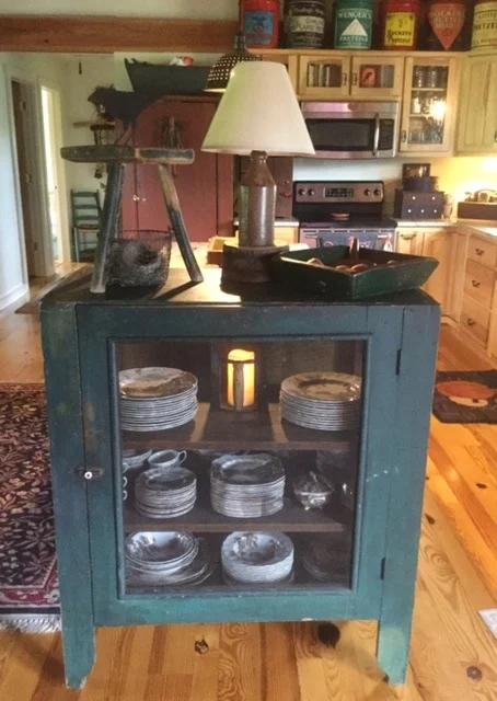 I just love this prim pie safe in original green finish. It has the screening on all four sides. My dishes have never been so happy!