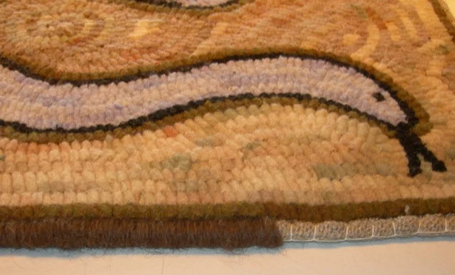 A bit of the edge binding.I always roll the linen over cord and baste in place before whipping with wool yarn.
