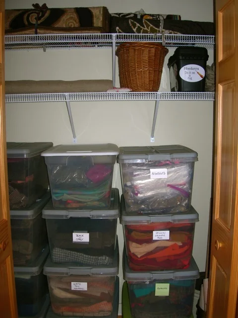 There are three closets in the room. This one holds my wool stash, linen, and rolled up finished rugs.