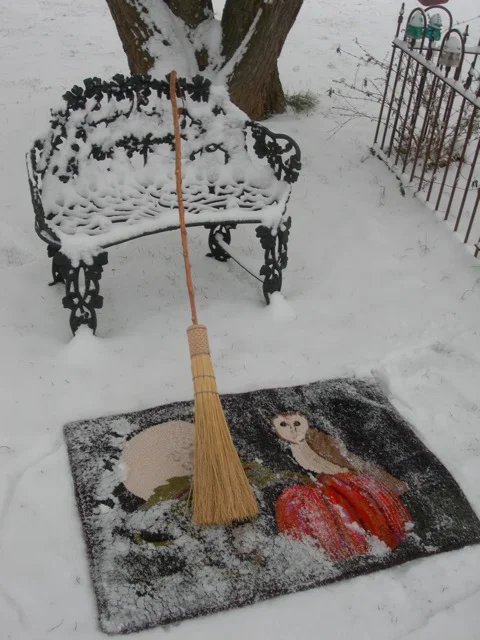 Flip the rug over and admire the beautiful snow on it! Start sweeping the snow off.