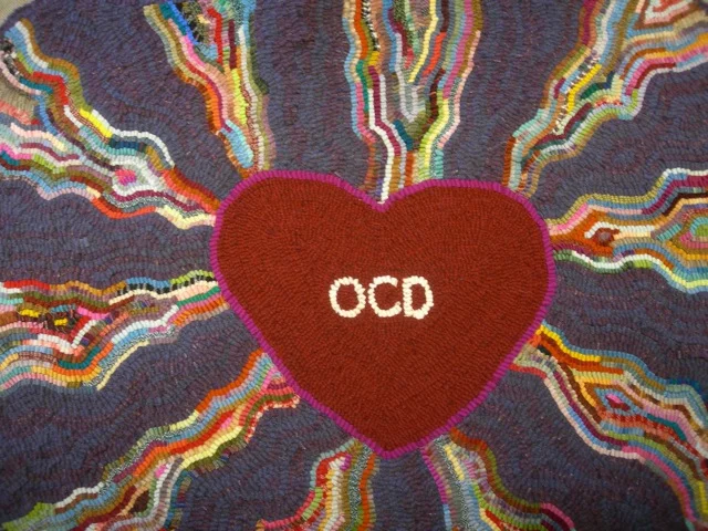 The center area of I Love My OCD 32” x 39”. Hooked with #8 and #8.5 cuts of wool cloth on linen.