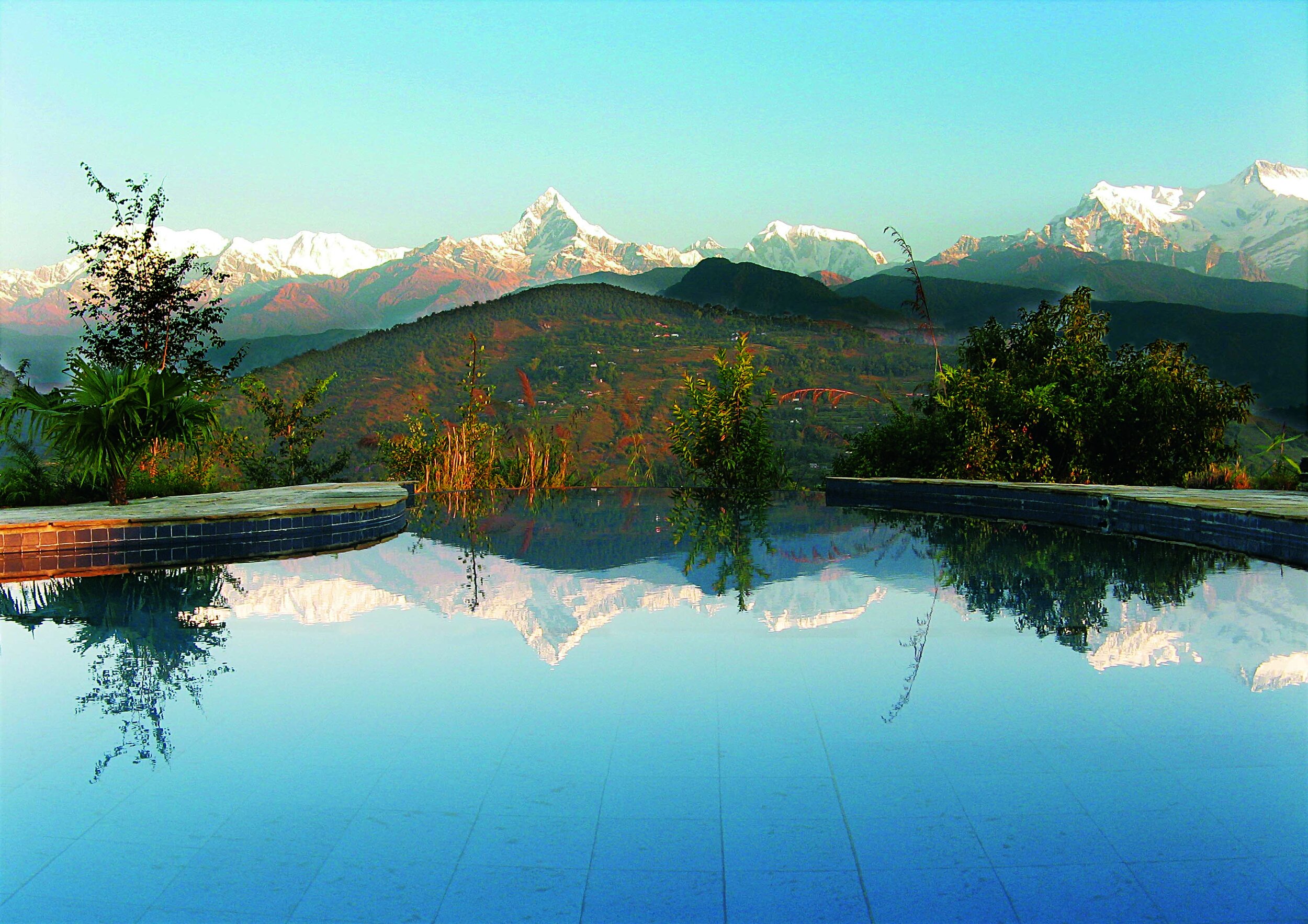 Mountains reflected on the Swimming Pool at TM Pokhara Lodge.jpg
