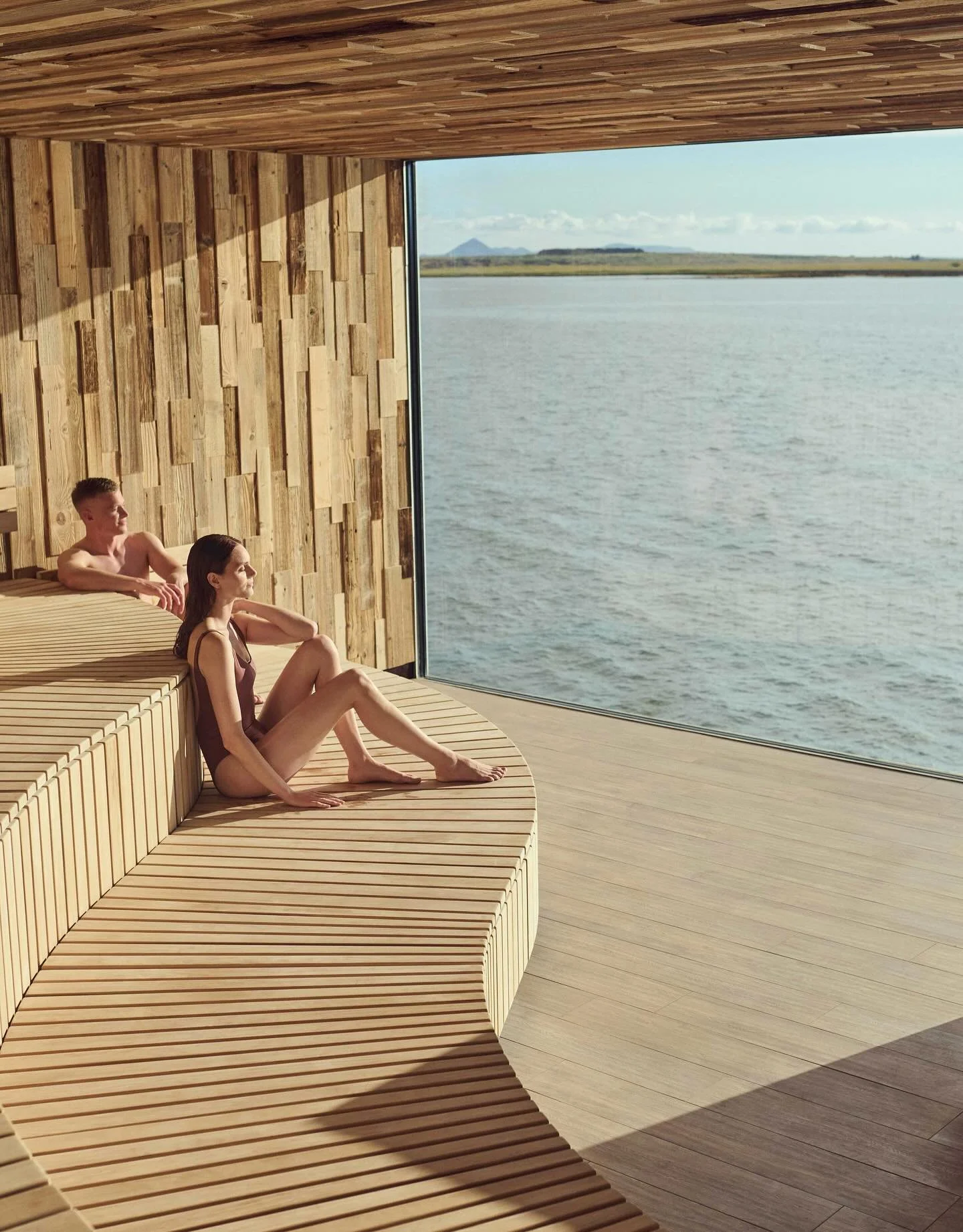 Carved into a moss-covered cliff on the K&aacute;rsnes Peninsula, Sky Lagoon is just minutes from Reykjav&iacute;k yet feels a world away. 

The geothermal infinity pool stretches toward Faxafl&oacute;i Bay, where fishing boats drift past and snow-du