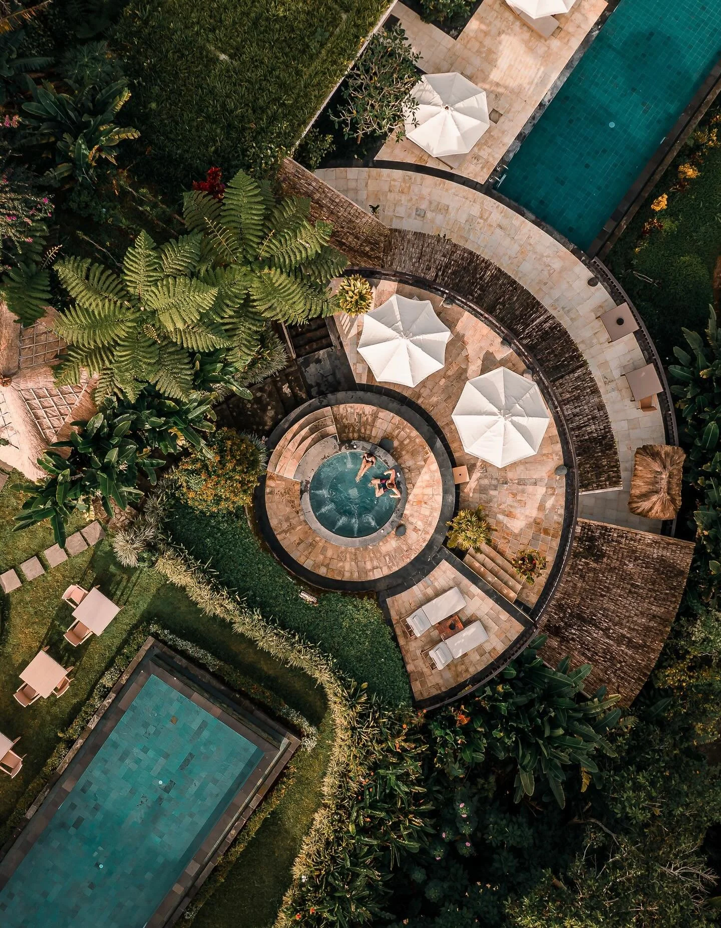 High in the hills of northern Bali, Munduk Moding Plantation is surrounded by clouds, coffee, and quiet. The resort sits on a working coffee plantation where mist rolls through bamboo groves and infinity pools appear to float above the treetops. Desi