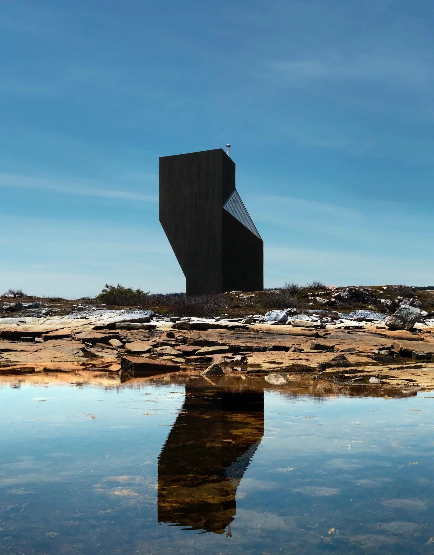 Fogo Island Inn is a masterpiece of modern vernacular architecture, a building that feels both radically contemporary and deeply rooted in place. Designed by Newfoundland-born architect Todd Saunders, the Inn rises on stilts above the rocks like a be