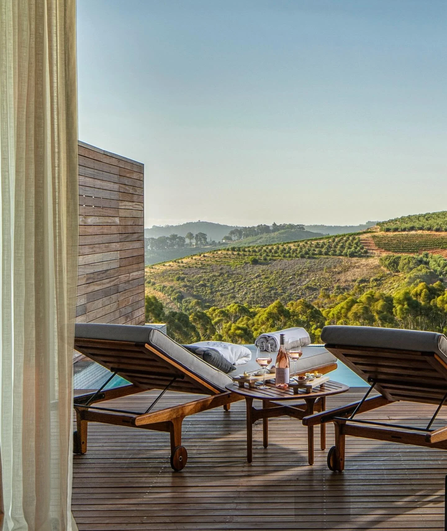 In South Africa&rsquo;s Stellenbosch winelands, where vineyards trace the folds of the Helshoogte Pass and mountains hold the horizon, Delaire Graff Estate brings art, architecture, and landscape into quiet alignment. Contemporary buildings unfold ac