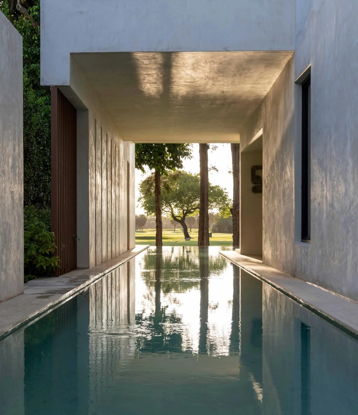 House of Light in Miami Beach is an exercise in restraint and sensory awareness, shaped not by style but by site, privacy, and the movement of light. From the street, a composition of solid volumes creates a quiet threshold, guiding arrival through a