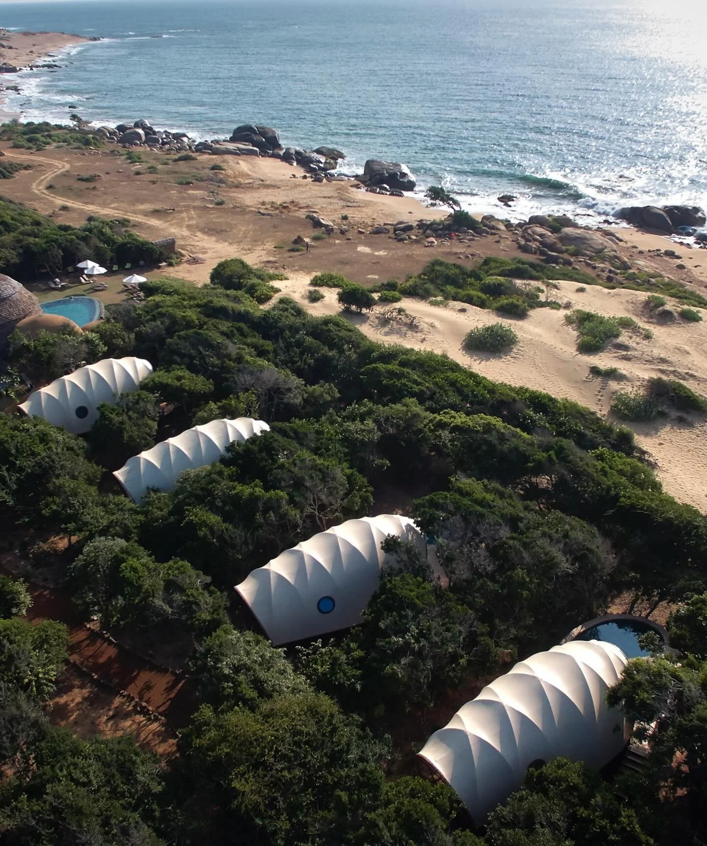 Wild Coast Tented Lodge unfolds where jungle, beach, and wildlife converge along Sri Lanka&rsquo;s southeastern edge, bordering Yala National Park and the Indian Ocean. Architecture is inspired by the form of boulders scattered along the coast, with 