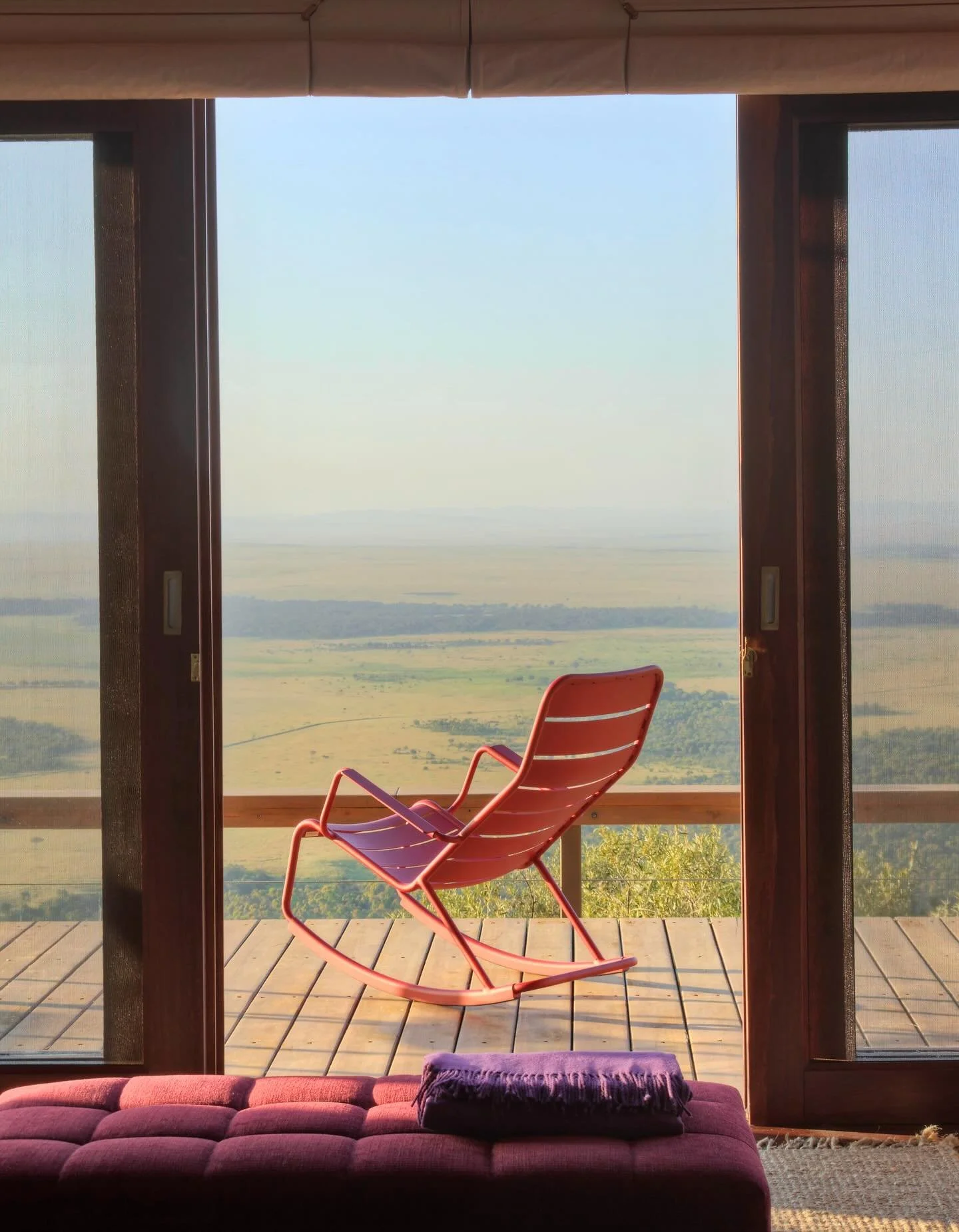 High above the Maasai Mara on the Great Rift Valley escarpment, Angama Mara offers sweeping views across the Mara Triangle, where elephants, lions, cheetahs, and the herds of the Great Migration roam. Tented suites with glass walls open fully to the 