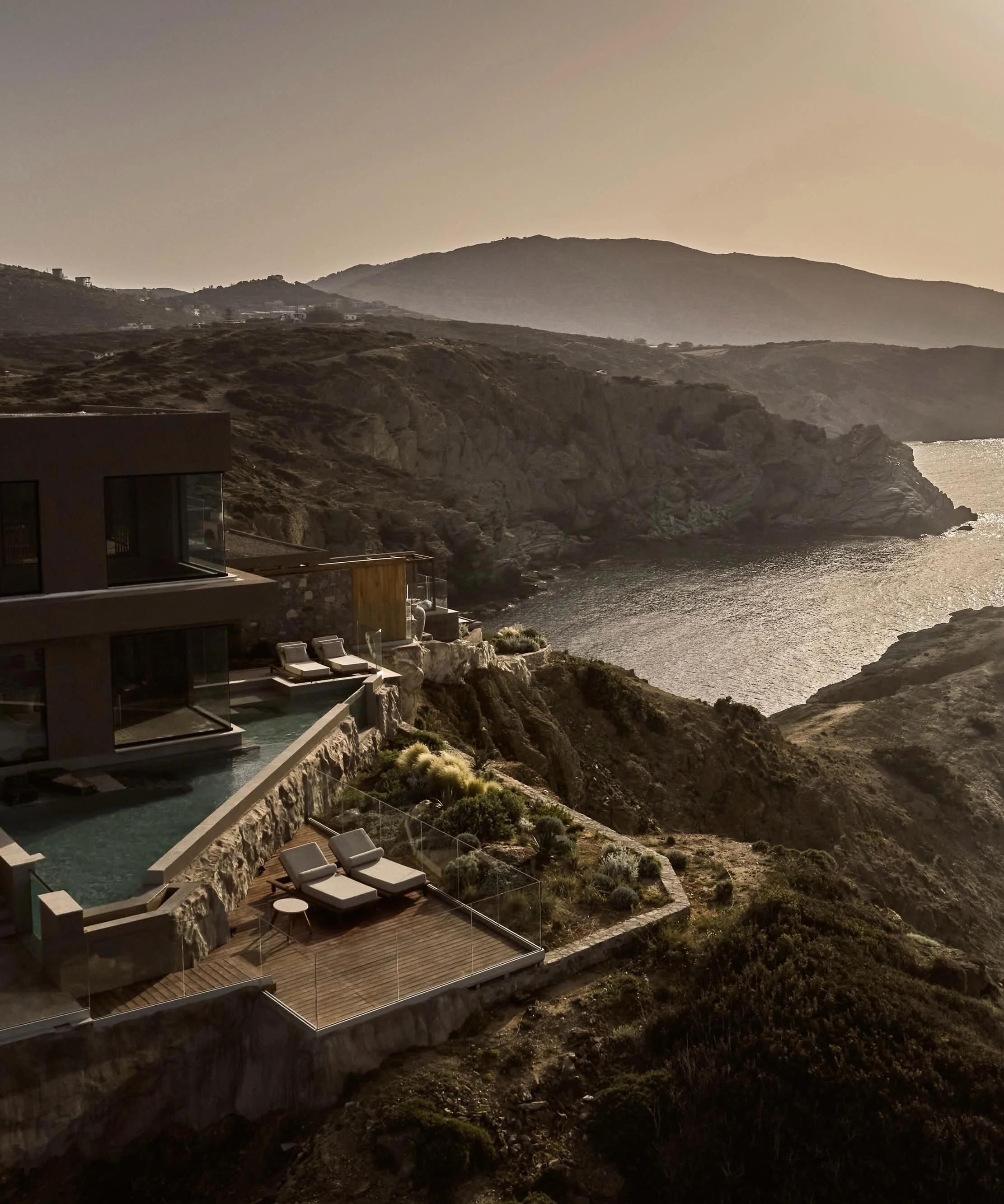 On the rugged northern coast of Crete, Acro Suites is carved into cliffs that fall toward the Aegean Sea. The geography is raw and vertical, shaped by limestone formations, wind exposure, and deep coastal light. The architecture is inspired by cave d