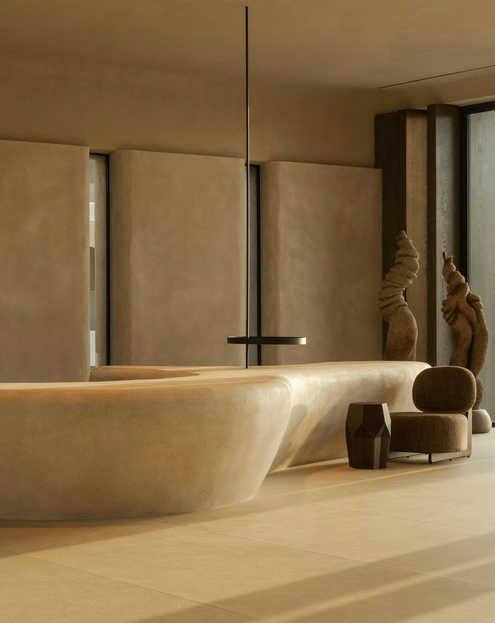 On its own private peninsula above Mirabello Bay, Minos Palace Resort feels like a contemporary sanctuary shaped by sea, stone, and light. The architecture is intentionally quiet&mdash;low-slung volumes, softened concrete, pale timber, textured plast