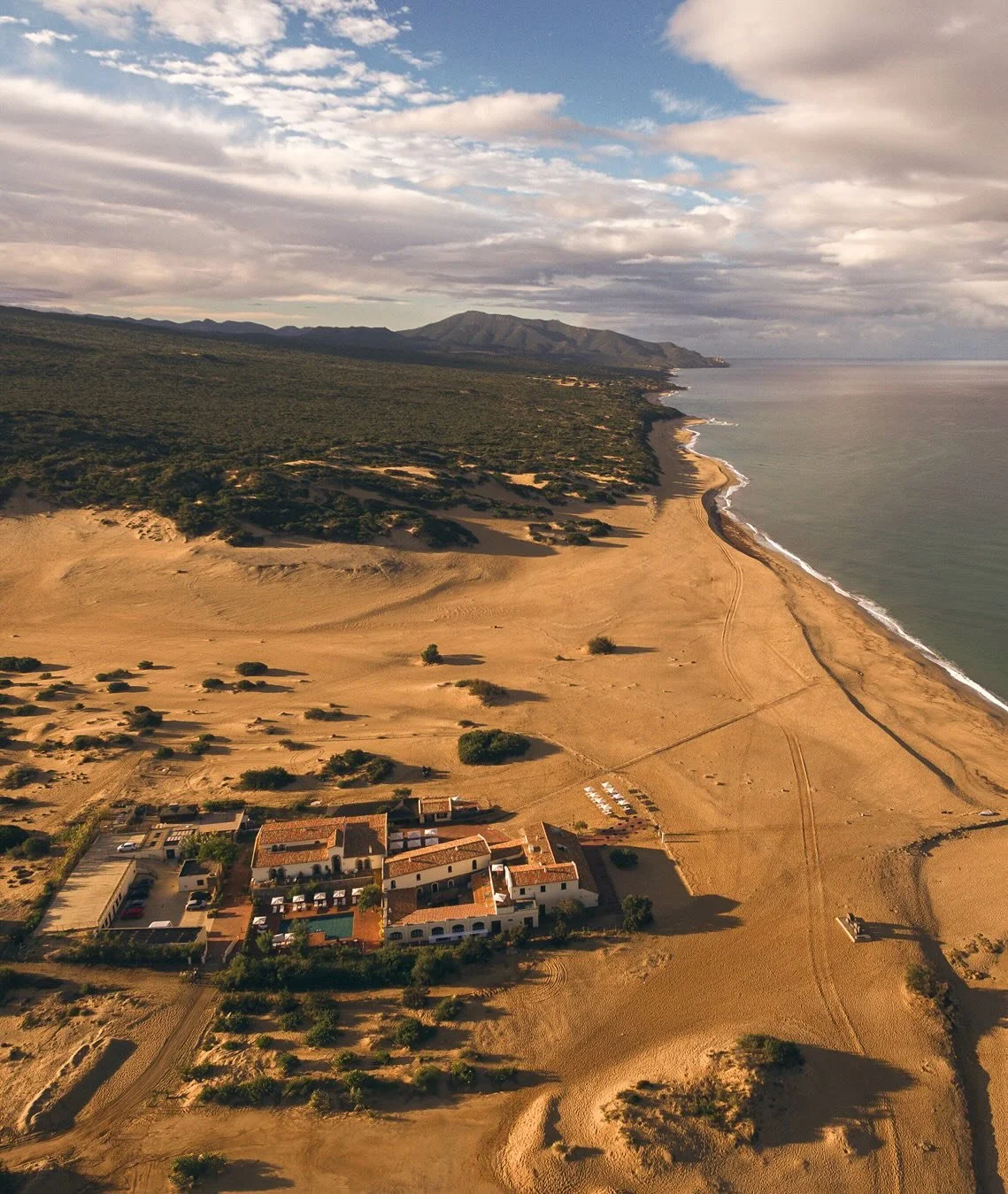 Le Dune Piscinas sits within one of Europe&rsquo;s most dramatic dune systems on Sardinia&rsquo;s southwestern coast, where wind has reclaimed a former mining landscape and returned it to a state of raw natural formation. The dunes here are vast and 