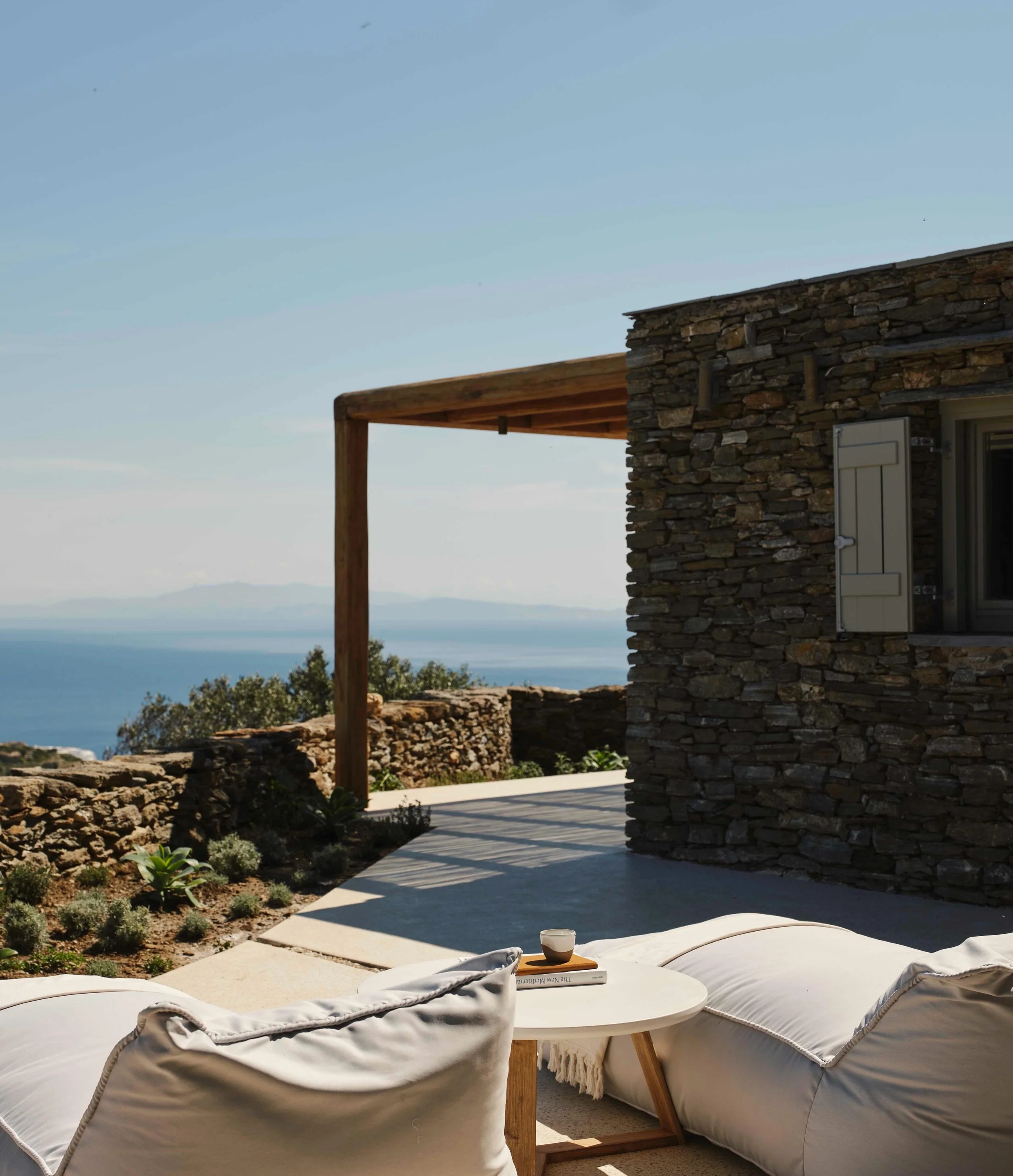 Set within the Cycladic landscapes of Sifnos, Stamna Sifnos reflects a quieter and more grounded side of the Greek islands. The geography is defined by dry stone terraces, olive groves, low hills, and hidden coves where the sea feels impossibly clear
