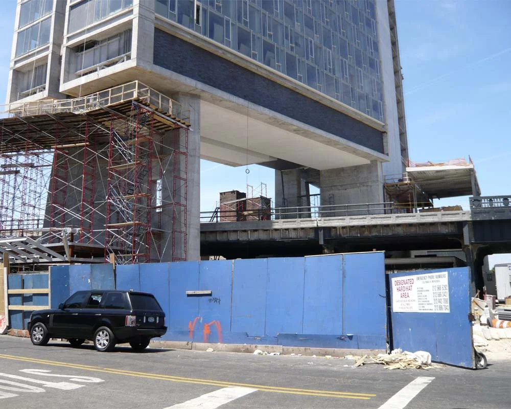 Renovating the structure of the High Line in 2008, prior to its reinvention as a park. The Standard Hotel is under construction over and above the rail line.