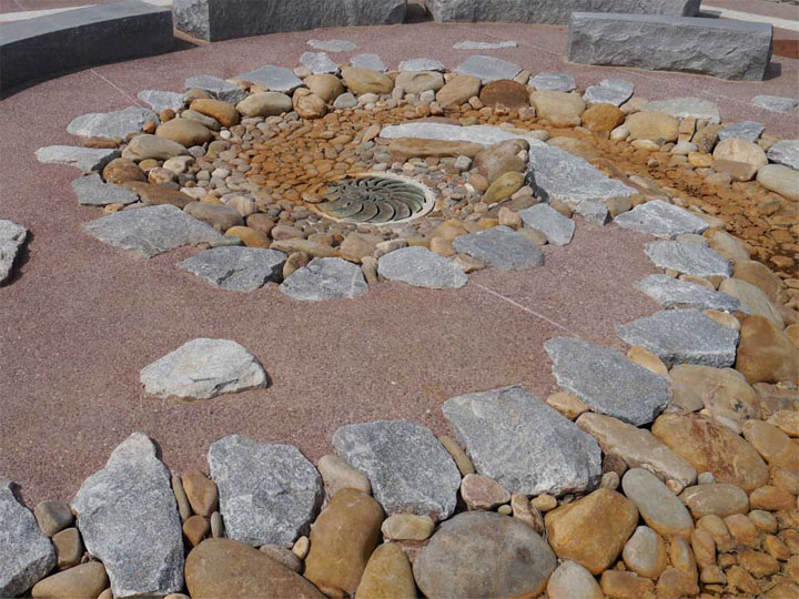 Runoff water follows the curve of this multi-textured stone spiral.