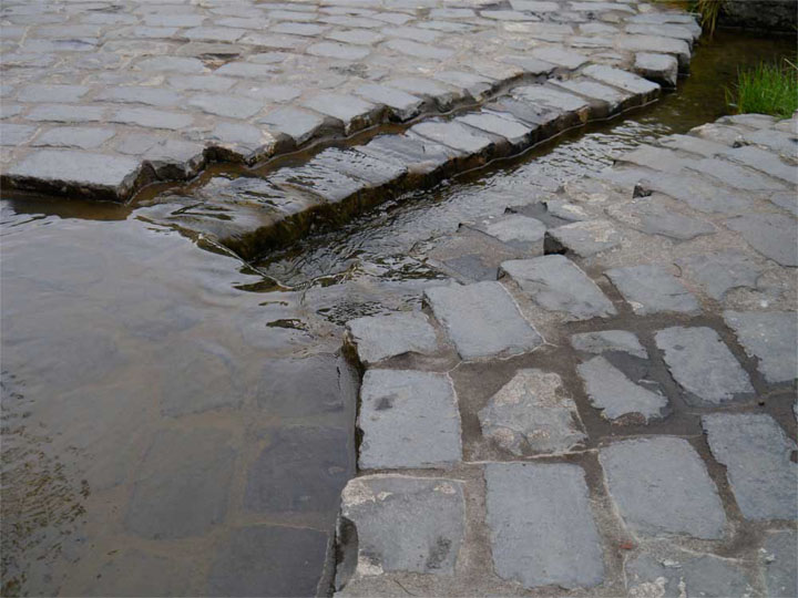  These pieces of stone look like they've been worn smooth by the water passing over.    