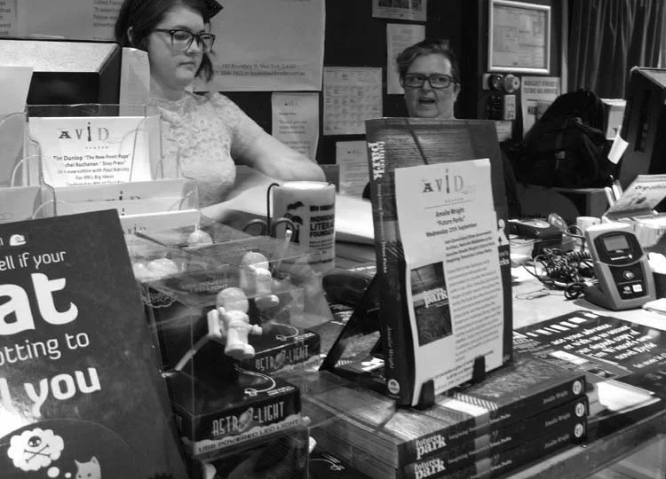 Ka-ching! Krissy and Krew helm the counter as the vast stockpile of books rapidly diminishes.