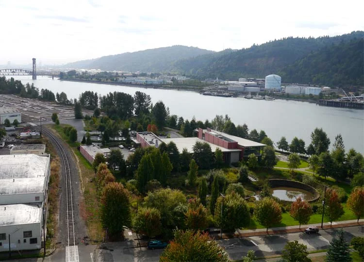The Water Pollution Control Laboratory is the red building in the centre of this image, surrounded by extensive gardens. Downtown Portland is on the opposite riverbank in the distance.