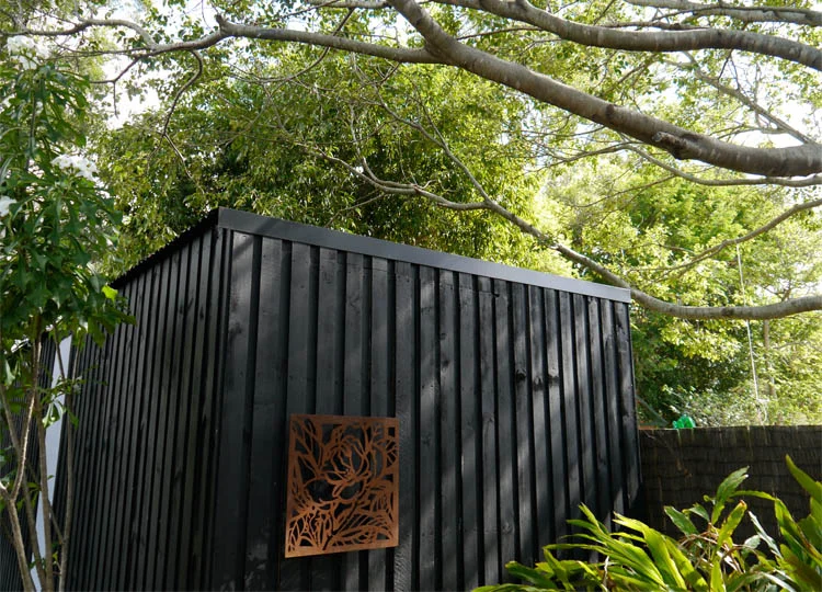 Chunky, dark stained timber wraps the pavilion. Translucent panels open to allow additional light and ventilation.