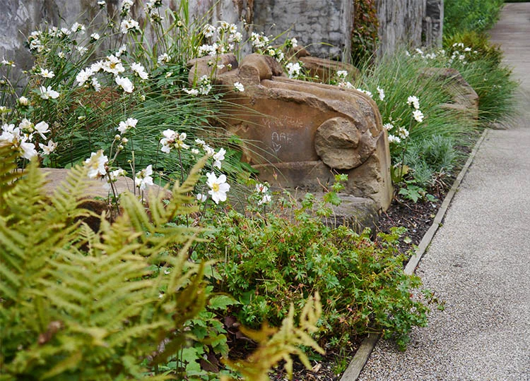 Retained architectural elements placed as garden sculptures.