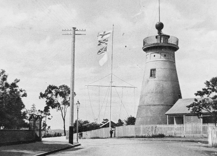 The time ball at the top of the tower and signal flags on the flagstaff in 1908. Image: State Library of Queensland.