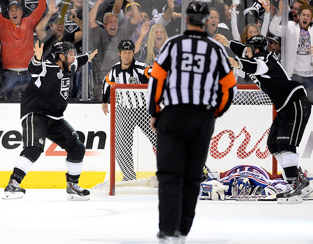 Alec Martinez, teammate, and the LA Fans go crazy after Martinez scored the game winning goal in double OT to capture the Cup while Henry Lundqvist laid in agony. Pictures are truly worth a thousand words. (Getty Images) 