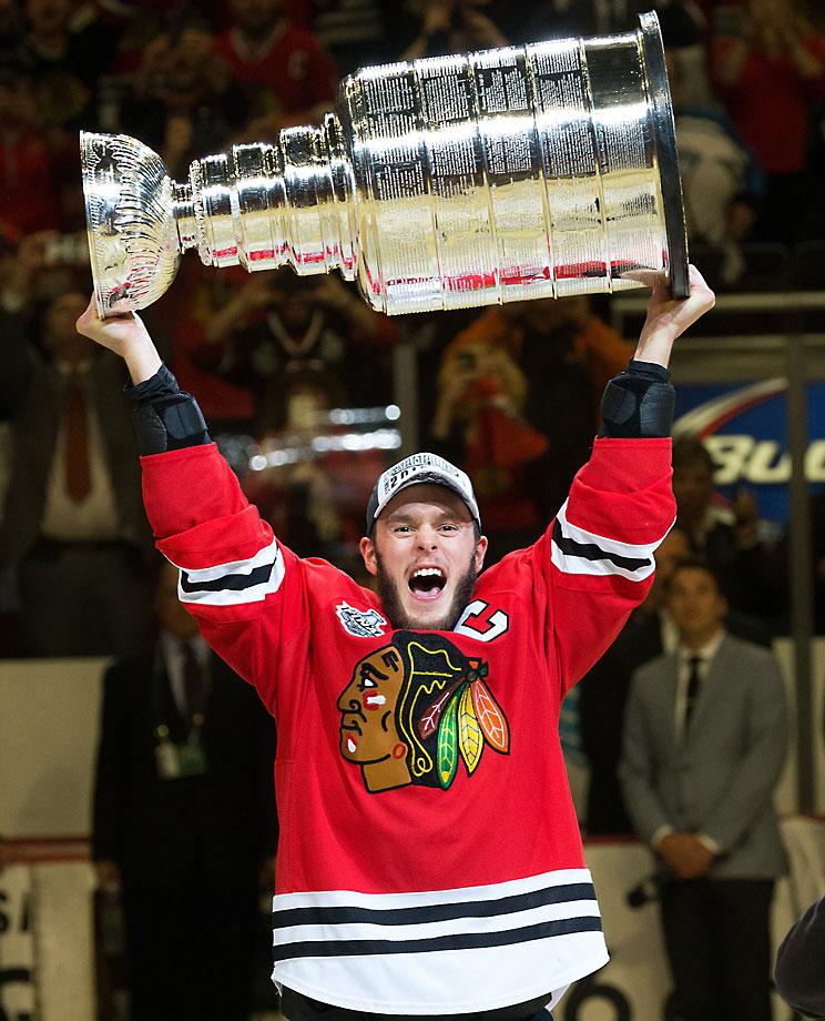 Johnathan Toews carries the Cup around the ice in front of a sold out United Center crowd. This was the first title won in Chicago on home ice since 1938. (David E. Klutho/Sports Illustrated)