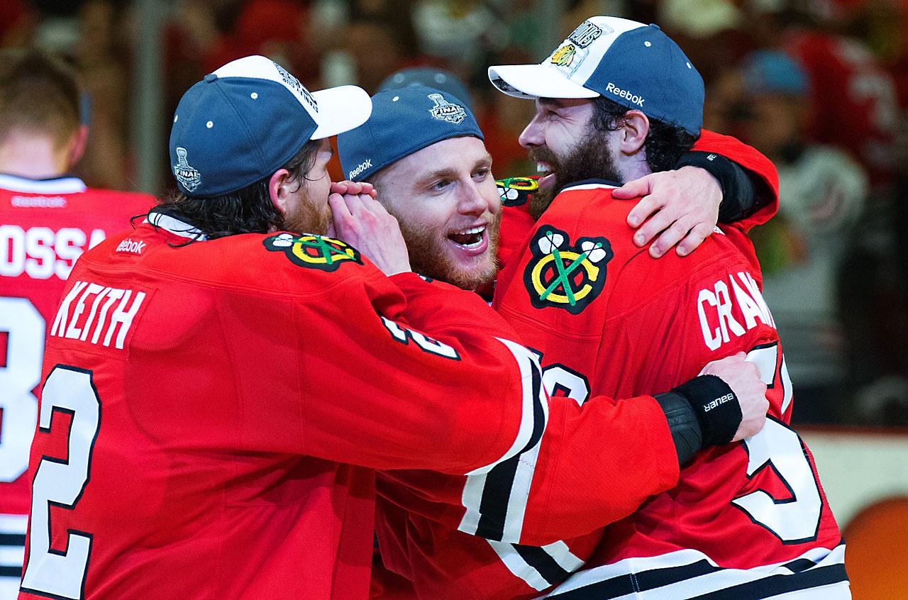 (left to right) Duncan Keith, Patrick Kane, and Corey Crawford all celebrate after winning game 6. Keith and Kane combined for 6 points during the Cup Finals, while Crawford posted his 5th shutout of the postseason. (David E. Klutho/Sports Illustrated)