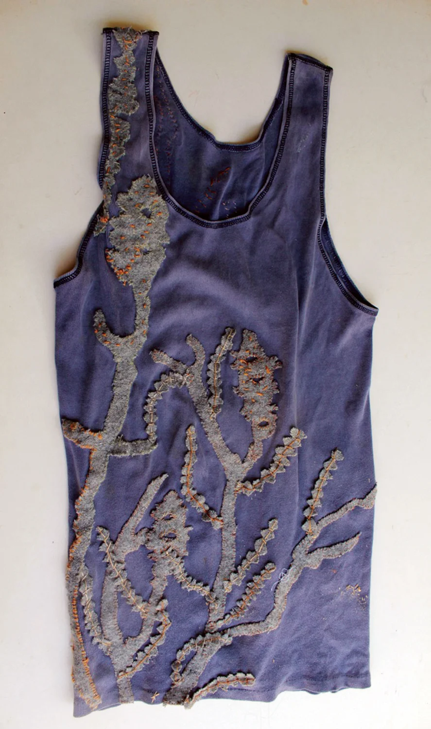  7. Nalda Searles,  Return , mans cotton singlet c.1998, grey blanket cut and stitched with linen thread,&nbsp; set with   The Shape Changers Slippers  &nbsp;  $2,900  