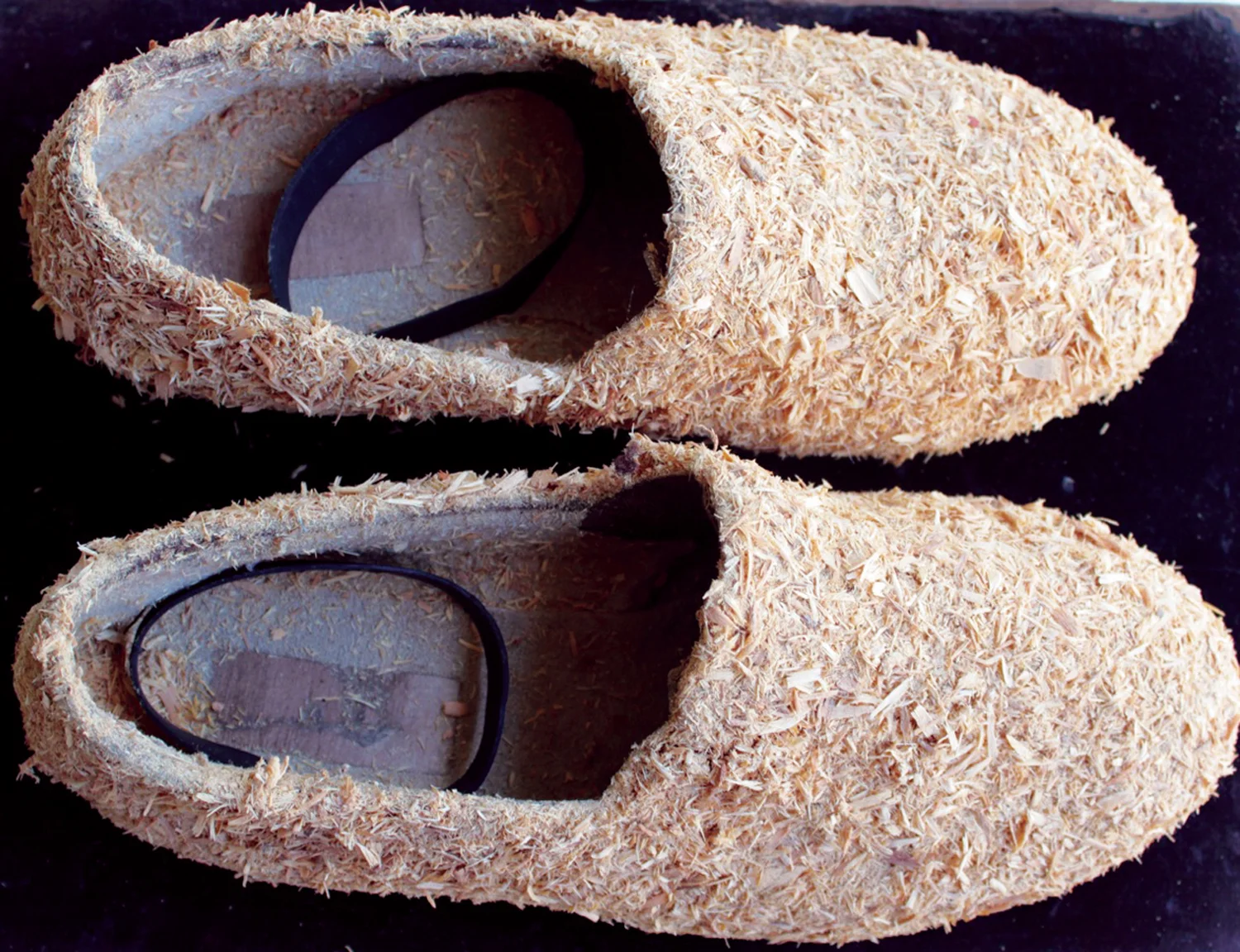  7. Nalda Searles,  The Shape Changers Slippers , mans slippers c.1997, sandalwood shavings from lathe work c.1993, rubber bowyangs, set with &nbsp;Return &nbsp;$2,900 