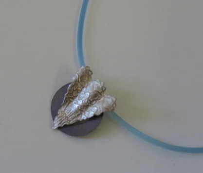  42.&nbsp; Time's Arrow , fine silver, titanium, rubber cord $135 