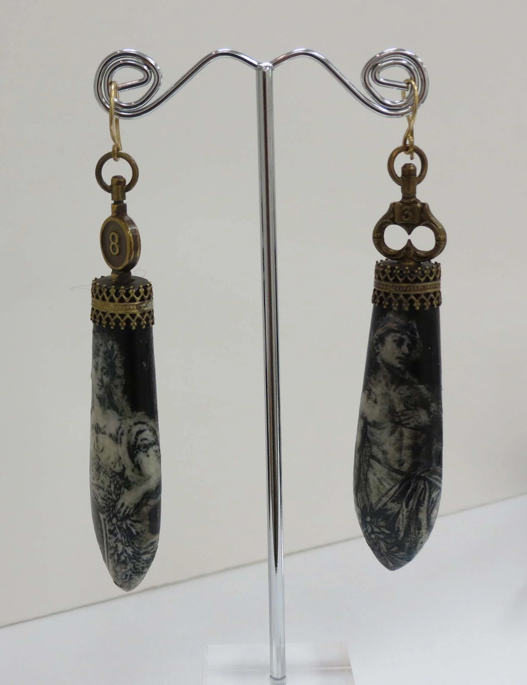  15. Kathy Aspinall, 'Ebony', 2018, Ebony, gallery wire, antique paper, watch keys, earrings, $300 