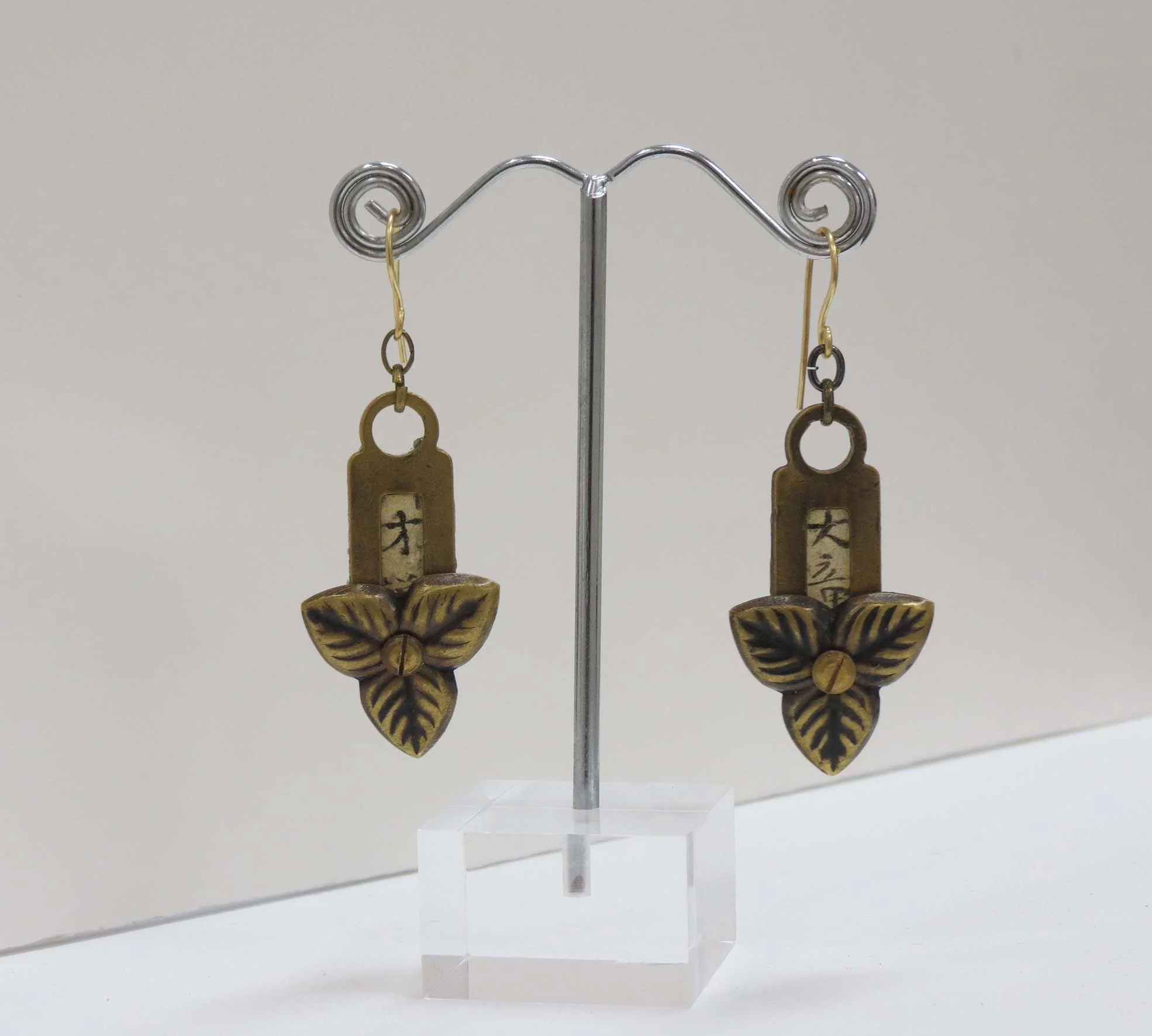  18. Kathy Aspinall, 'Brass', 2017, brass, Japanese paper, resin, earrings, $175 