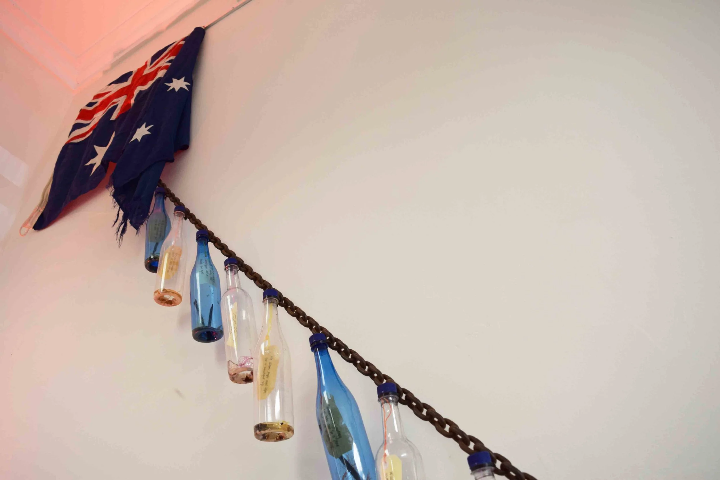  13.  Migration Messages  (detail), 2013, textiles, plastic, card, steel shipping chain, 300 x 10 x 1000 cm. $1,000 