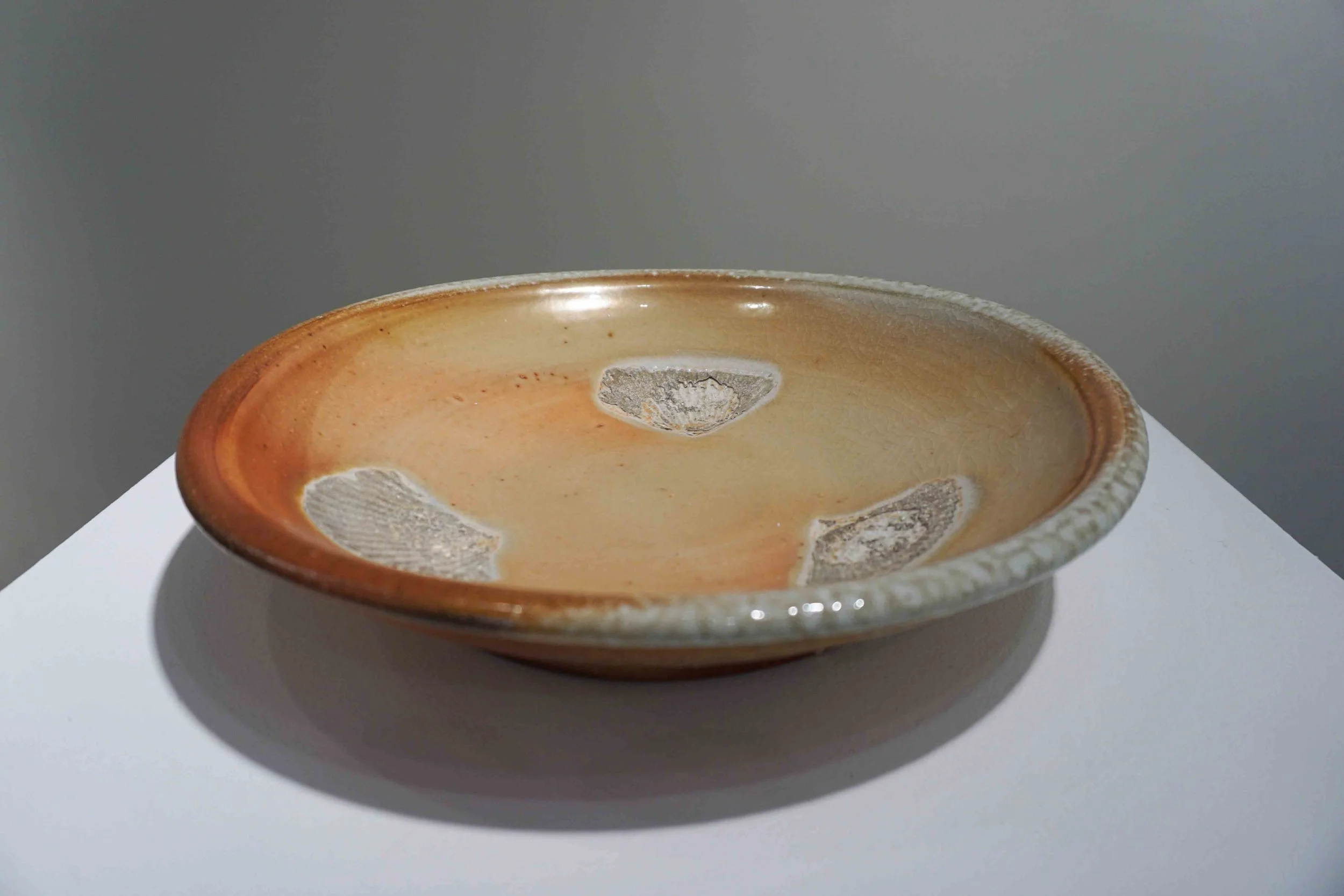  11. Greg Crowe,  Dish,  2015, woodfired stoneware, 7 x 34 x 34 cm $750 