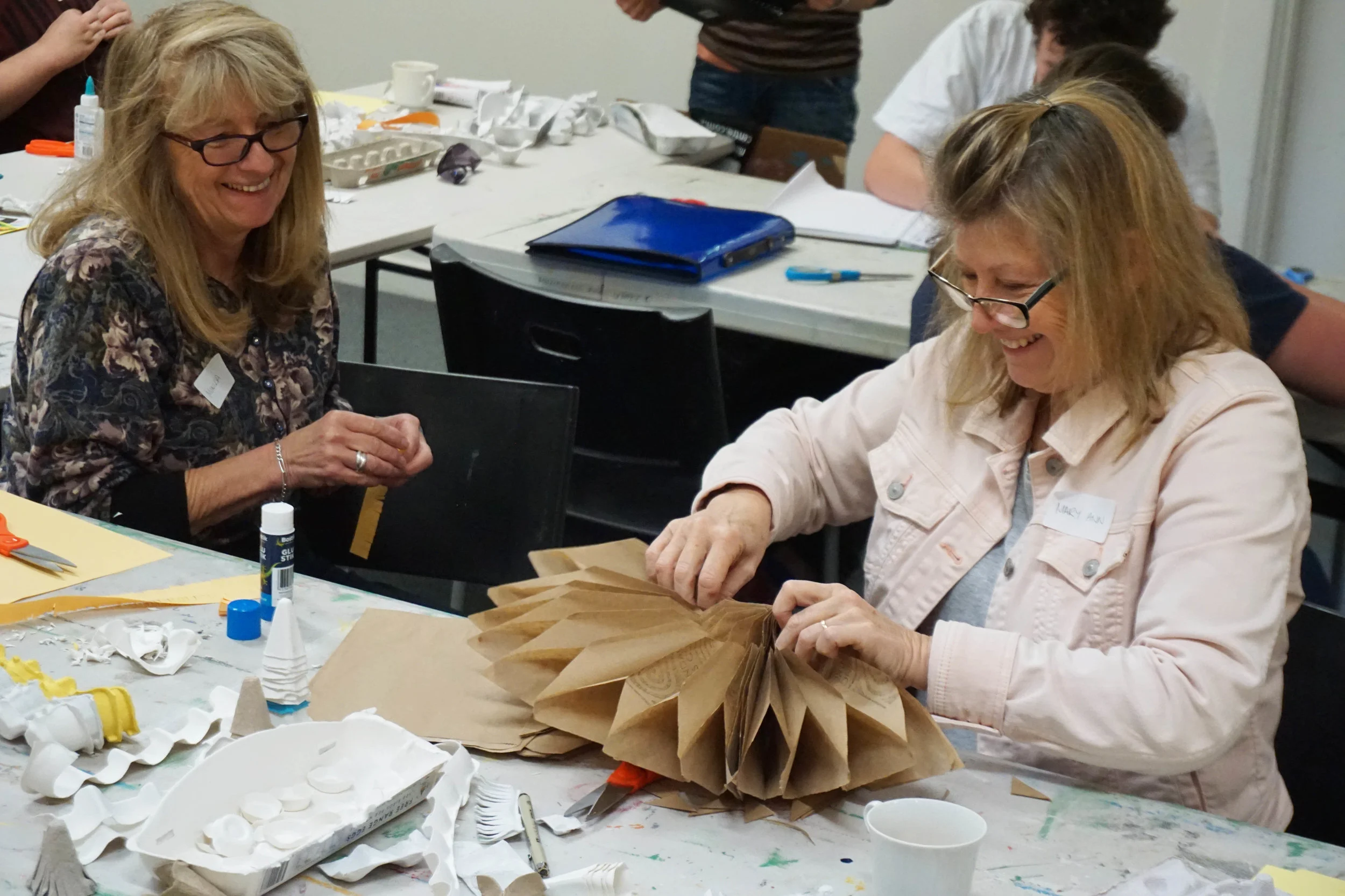 MAC volunteers making paper flowers for What On Earth.jpg