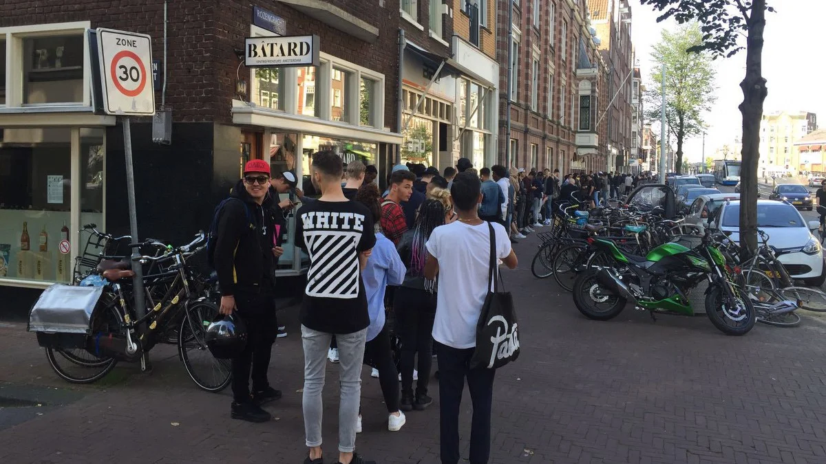 Shoppers wait in long lines at the launch of Kanye West's pop up store on Amsterdam's Rozengracht. Image credit: AT5
