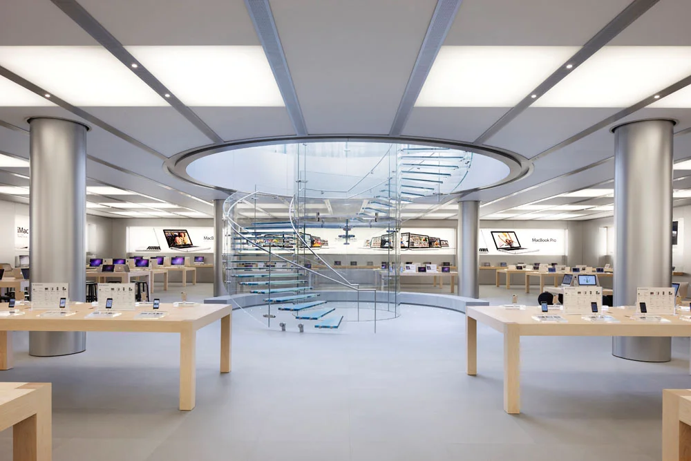 Apple Store Design. Apple uses a lot of white light and presents its products with a lot space between them. The design of the products is replicated in the pure and clean store design.