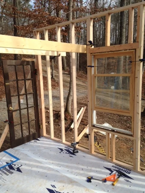 A view from inside. The boards clamped between the door and the window (above) represent where the floor joists for the sleeping loft will be. 