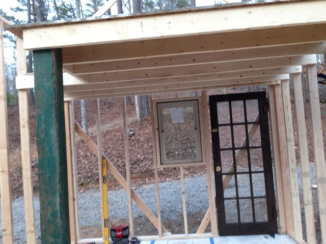 The framing for the loft. The green post supports the parts that are not supported by opposing walls. I reclaimed the post from a friend's deck remodel.