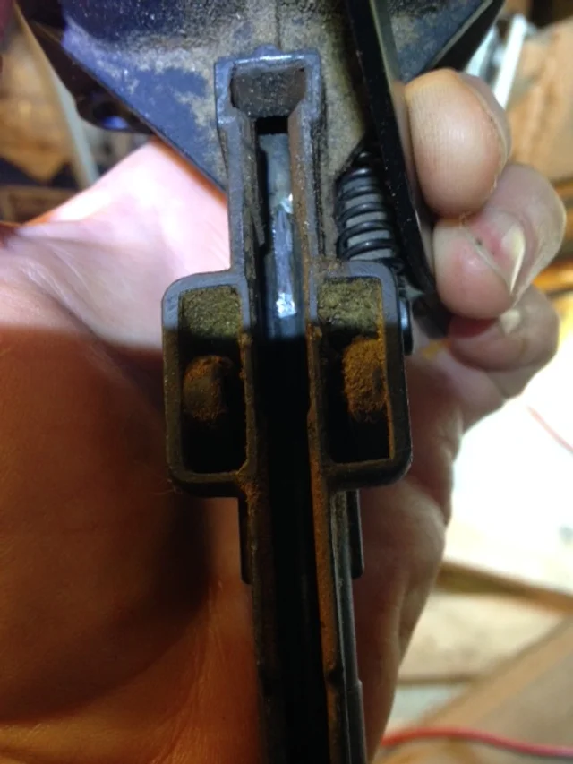 The shiny part about a third of the way from the left is the 1/2" piece of nail that was jammed in. This after I've dislodged the hammer mechanism. It was still wedged into the sleeve of the gun, but getting it tapped out was relatively easy. 