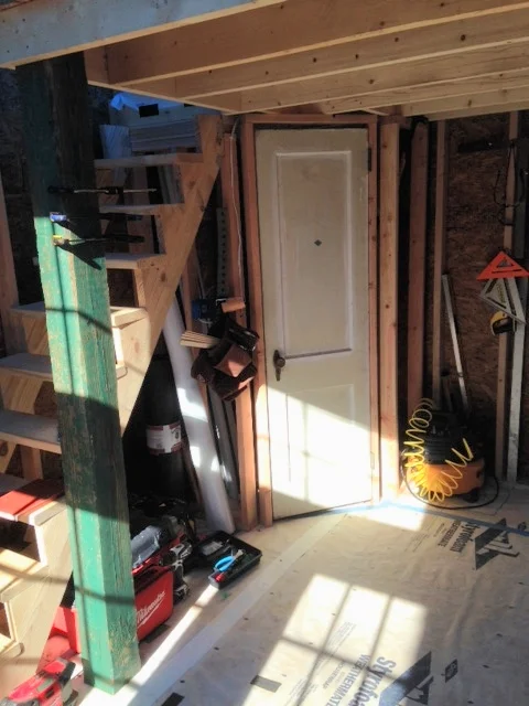 The bathroom door is installed and the bath framed out. I call it a bathroom...actually, I guess it's just a pee/poop room! It's actually quite spacious when you compare it to other tiny houses I've seen. If, at some point, we want to add a shower, there is probably enough room.