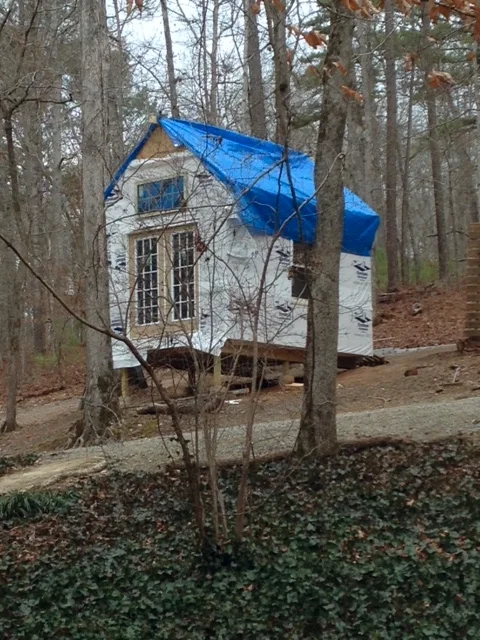 Here's a view I haven't shown before. This is taken from the wood walkway that leads from the main house. Didn't get the sheathing down on the roof before last week's rain, so I tarped the rafters temporarily. It kept 95% of the rain out. 