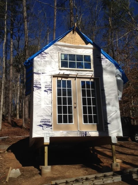 Installed the french doors yesterday. It was not an easy job to do alone. Each door weighs close to 100lbs. Thinking about building the deck next, before I sheath the roof. It may give me a better foundation to work from.