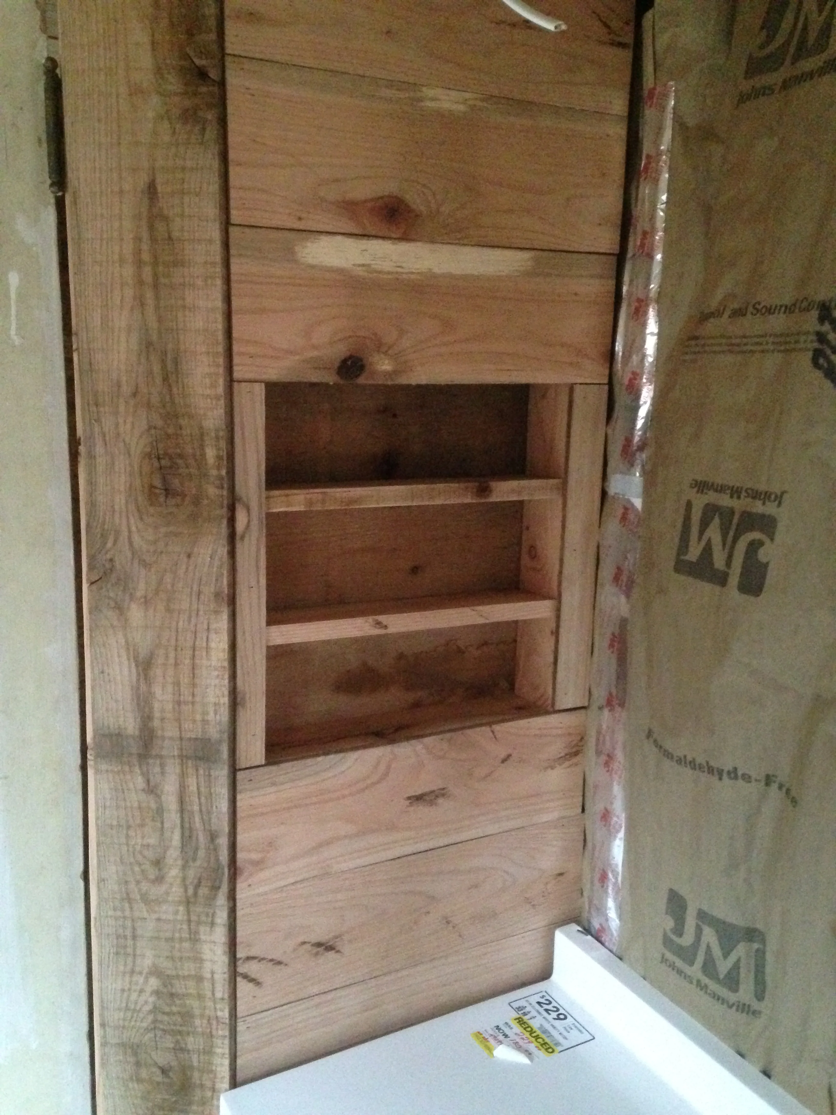 This is the wall next to the vanity we bought this week. I recessed in some hand-cut shelves I made from excess scrap for storing toiletries, coffee cups, etc. 