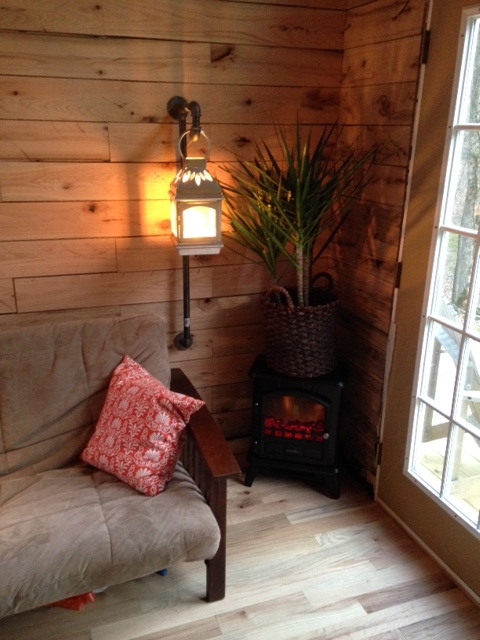 We have a faux wood stove heater. It is small, but will heat the space with ease. I made a lantern lamp with the same plumbing pipe I used for the handrail and loft guardrail.