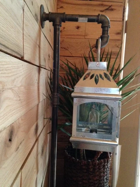 I ran the wiring through the wall and the pipe. I installed a simple bulb holder with a twist switch protruding out the bottom. It was originally intended to hold a candle.