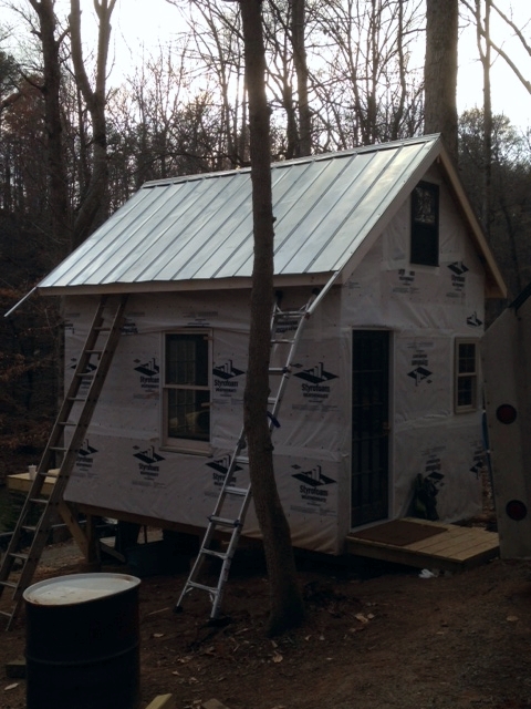 The roof, almost finished. We have to trim the gable drip edges and install the eave drip edges, then we'll be good up top. Some siding, and a bunch of little work, and it should be inhabitable. 