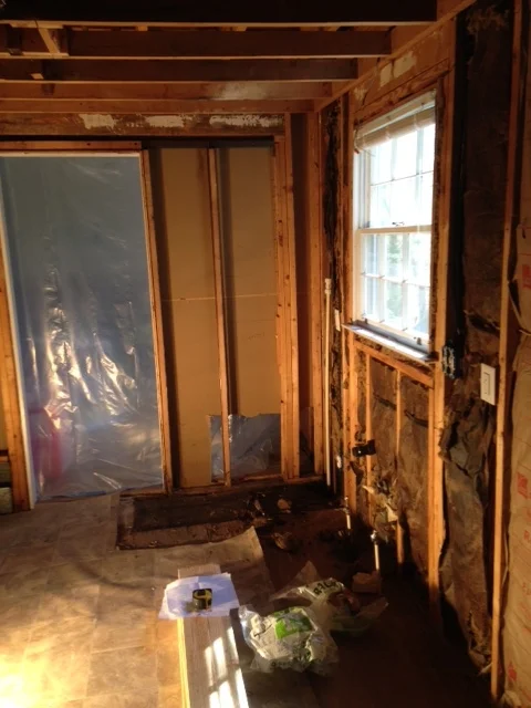 The customers wanted to open up the kitchen at the same time, so I took out the far wall and put in a full length header. They wanted to keep in a couple of knee walls so that the kitchen cabinets would butt up against something, and they wouldn't have to remove the ducting and electrical on the left side.